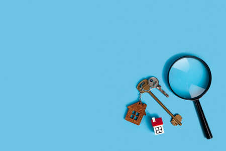 Find a home or a flat concept. Toy model house, money, magnifier and keys. Rent apartments, Real...
