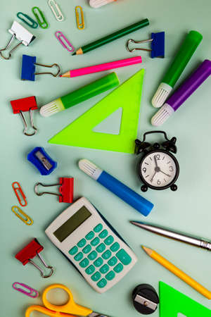 Back to school concept. Colorful school or office supplies on green table. Flat lay, top view, copy space.の写真素材