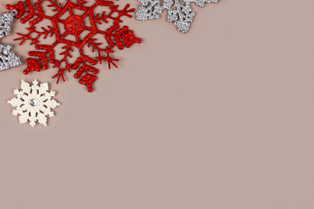 Christmas card template. Silver and white Christmas snowflakes on a pastel brown background. Greeting card design in retro style.の写真素材