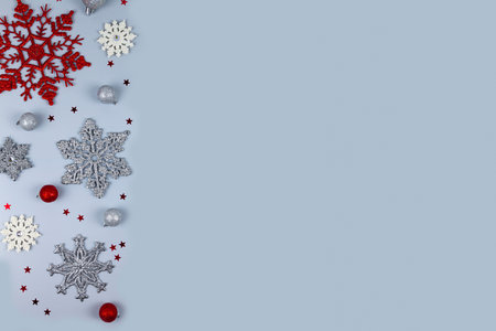 Christmas card template. Beautiful Christmas balls, snowflakes and stars on a pastel blue background. Greeting card design in retro style.の写真素材