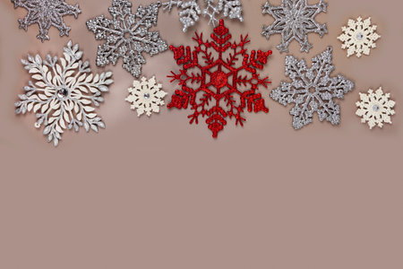 Christmas card template. Silver and white Christmas snowflakes on a pastel brown background. Greeting card design in retro style.の写真素材