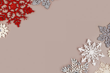 Christmas card template. Silver and white Christmas snowflakes on a pastel brown background. Greeting card design in retro style.の写真素材