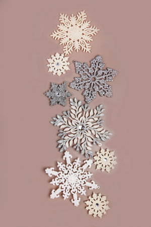 Christmas card template. Silver and white Christmas snowflakes on a pastel brown background. Greeting card design in retro style.の写真素材