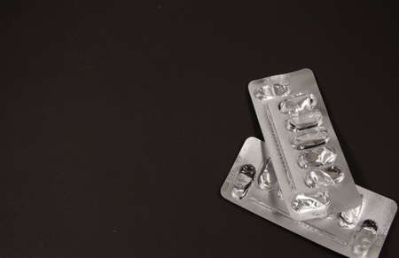 Two empty silver blisters from pills on a dark backgroundの写真素材