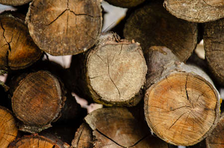 Neatly stacked wooden logs. A lot of cut wood as a background. Barbecue logs