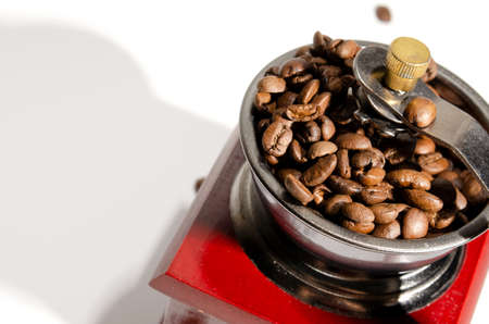 Mechanical manual retro coffee grinder. On a light background. Close-up. Coffee beansの写真素材