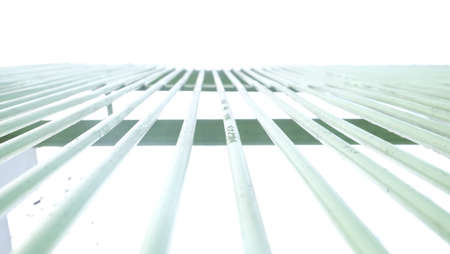 The fence of the house stands proudly against the background of the blue sky during the day.の写真素材