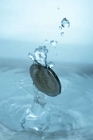 A coin splashes into waterの写真素材