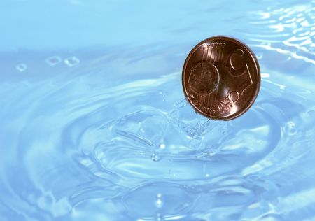 A coin drops into waterの写真素材