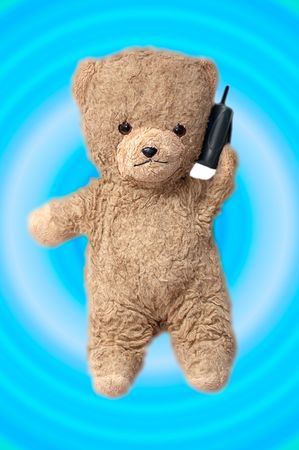 teddy bear on the phone against a blue and white backgroundの写真素材