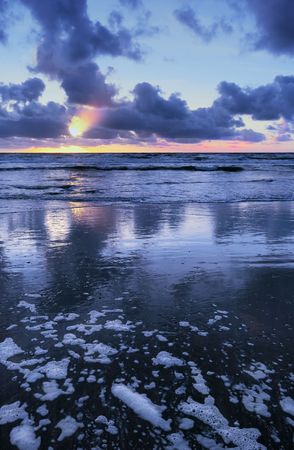 Sunset on a beach in the netherlands with blue colorsの写真素材