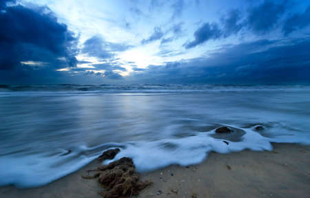 waves taken with a slow shutterspeed on a beach in the netherlandsの写真素材