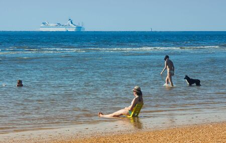 people at the beach on a hot summer dayの写真素材