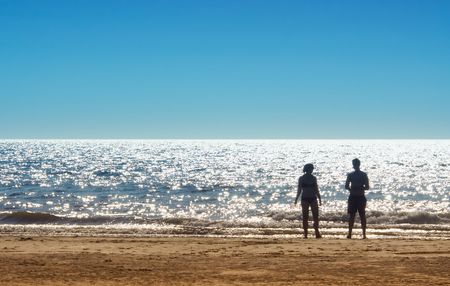 man and woman on a beach in summerの写真素材