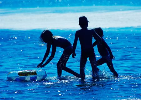 Kids playing in the waterの写真素材