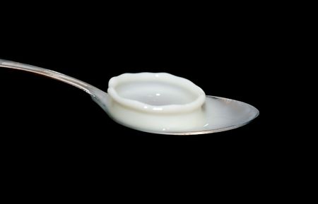 milk splash on spoonの写真素材