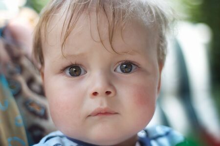 a little boy looking a bit scaredの写真素材