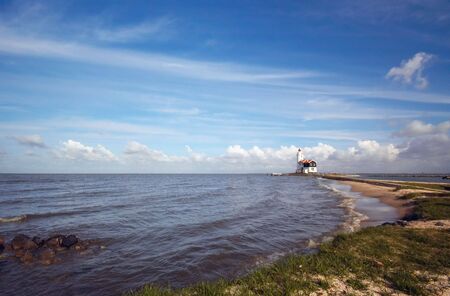 Landscape photo of a beach and a lighthouseの写真素材