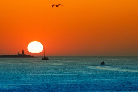 sunset and ships in the harborの写真素材