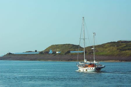 sailboat leaving harborの写真素材