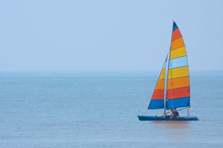 colorful sailboat and blue waterの写真素材