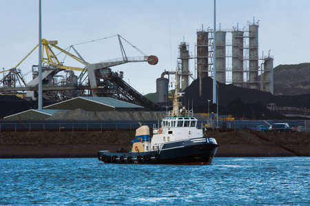 tugboat and industry in the harborの写真素材