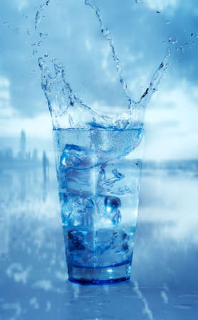 glass with splashing waterの写真素材