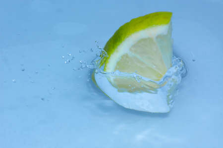 lemon splashing into fresh waterの写真素材