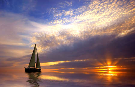 Sailing with a beautiful sunsetの写真素材