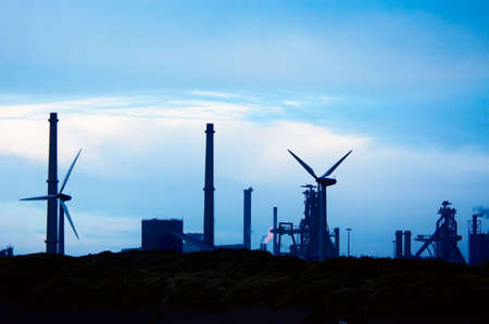 Industry and windmills with a blue sunset skyの写真素材
