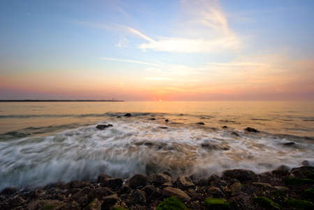 sunset and waves ( taken with a slow shutter speed )