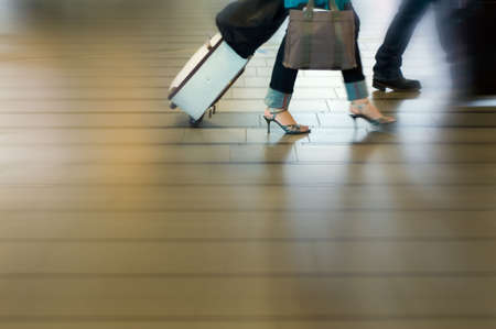 people traveling at the airport ( motion blur)の写真素材