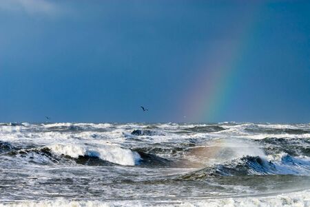 ocean and raindbow during storm の写真素材