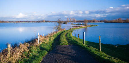 a road into a flooded river (IJssel river Netherlands)の写真素材