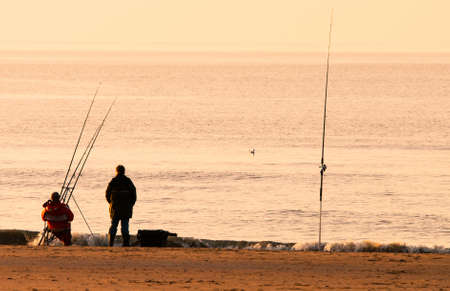 fishing on the beach in the eveningの写真素材