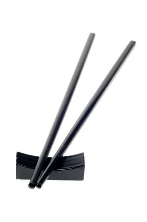 black chop sticks isolated on a white backgroundの写真素材
