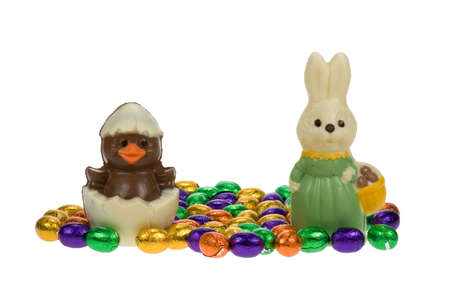 cute easter bunny and chick surrounded by chocolate easter eggs isolated on a white background