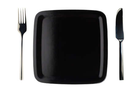 trendy isolated black plate with knife and forkの写真素材