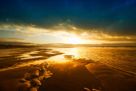 beautiful sunset and waves on the beachの写真素材