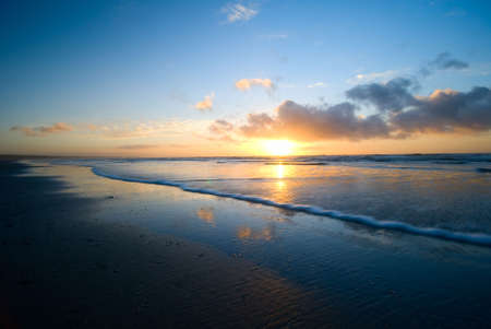 beautiful sunset and waves on the beach