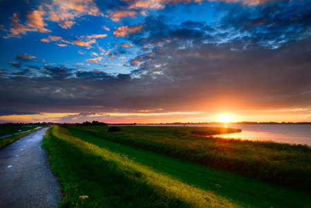 beautiful sunset and a country road の写真素材
