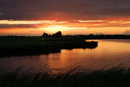 beautiful sunset at a lake in the netherlandsの写真素材