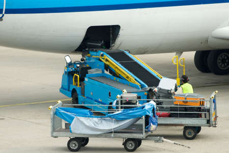 loading suitcases on plane at the airport