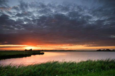 beautiful sunset at a lake in the netherlandsの写真素材