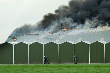 a huge fire with firefighters in action の写真素材