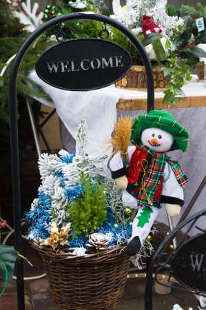 snowman and christmas tree with welcome signの写真素材