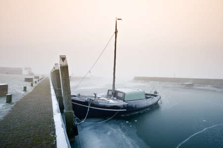 Dutch sailing boat on a cold day in winter (Friesland, The Netherlands)の写真素材