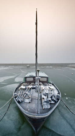 Dutch sailing boat on a cold day in winter (Friesland, The Netherlands)の写真素材