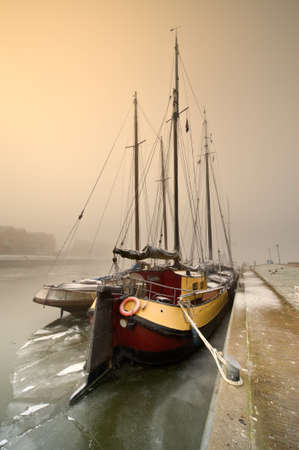 Dutch sailing boat on a cold day in winter (Friesland, The Netherlands)の写真素材