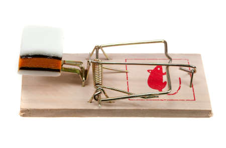 conceptual image of  candy on a mouse trap isolated on a white backgroundのeditorial素材